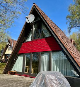 a house with a red roof with a satellite at Natur Pur-Waldurlaub im Tiny House in Ronshausen