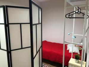 a sliding glass door with a red bed in a room at -Precioso apartamento en pleno corazón de A Guarda in A Guarda