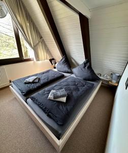 a bedroom with two beds with blue sheets and pillows at Natur Pur-Waldurlaub im Tiny House in Ronshausen