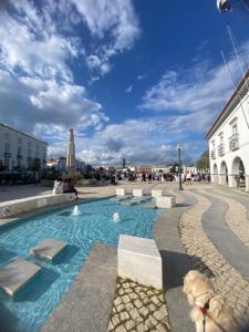 a pool in the middle of a street with a building at Portugals Infinity Eco Suite Resort in Tavira
