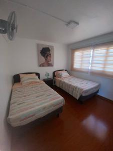 Postel nebo postele na pokoji v ubytování Hospedaje Nuevo Amanecer