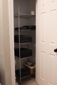 a closet with a rack of folded towels at Hubbs Cellar at JS Hubbs Guest House in Hammondsport