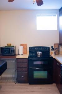 a kitchen with a stove and a microwave at Hubbs Cellar at JS Hubbs Guest House in Hammondsport