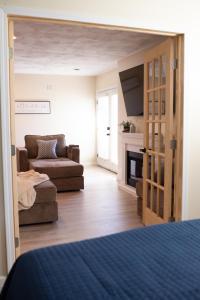 a room with a bed and a couch and a fireplace at Hubbs Cellar at JS Hubbs Guest House in Hammondsport