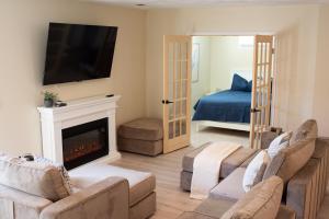 a living room with a fireplace and a bed at Hubbs Cellar at JS Hubbs Guest House in Hammondsport