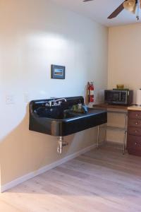 a kitchen with a black sink on the wall at Hubbs Cellar at JS Hubbs Guest House in Hammondsport