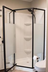 a glass shower in a bathroom with a toilet at Hubbs Cellar at JS Hubbs Guest House in Hammondsport +12 photos