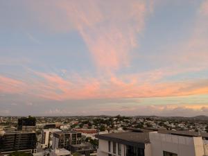 a view of a city with a cloudy sky at Bedroom with Private Bathroom in cozy shared appartment! in Brisbane +3 photos