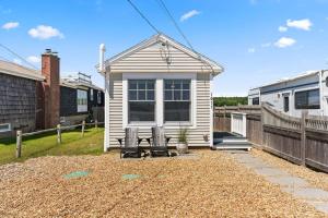 a small house with two chairs in a yard at The Surf Ocean & Marsh Views Rooftop Deck in Rye