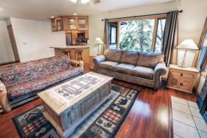 a living room with two couches and a table at Sunnyside Knoll- 6 cabin in Estes Park