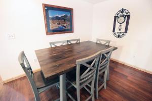 a dining room table with chairs and a clock on the wall at Sunnyside Knoll- 6 cabin in Estes Park
