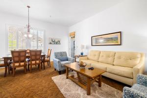 a living room with a couch and a dining room at LV262 2BR 2BA Legacy Villa with Mnt Views in La Quinta