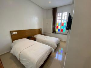 מיטה או מיטות בחדר ב-Hotel Lutece