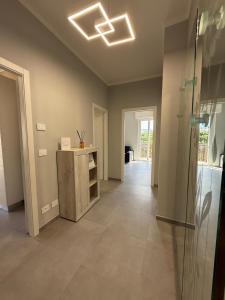 an empty living room with a light fixture on the ceiling at Casa Deodato in Diano Marina +5 photos