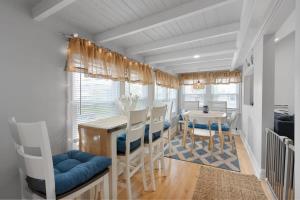 a kitchen and dining room with a table and chairs at Newly Renovated Beachside Bliss Steps to Sand in Salisbury +47 photos