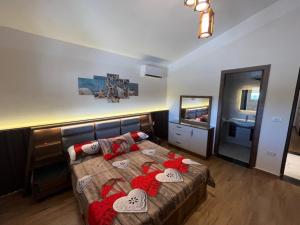 a living room with a bed and a television at Amoun sea view in Qaryat Shurūq