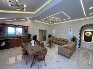 a living room with a table and a couch at Amoun sea view in Qaryat Shurūq