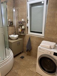 Ванна кімната в Jak apartman