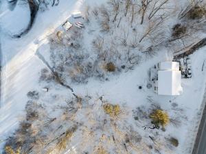 an overhead view of a snow covered street with trees at Winnisquam Landing Lakefront Firepit Deck in Tilton