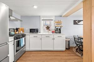 a kitchen with white cabinets and a stove top oven at Addie Shack & Cammie Cabana Pet Friendly 10pp in Salisbury