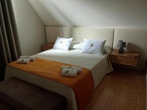 a bedroom with a large bed with two white pillows at Casa das Pias in Ribalonga +88 photos