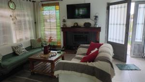 a living room with two couches and a table at Los Abuelos in Duggan
