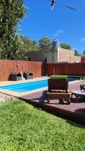 a swimming pool with a bench and a picnic table at Los Abuelos in Duggan