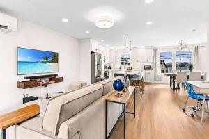 a living room with a couch and a dining room at Sunset Views Balcony Marsh Views AC in Hampton +85 photos