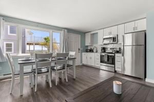 a kitchen with a table and chairs and a refrigerator at Harbor Serenity Private Deck Updated Kitchen in Rye
