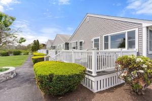 a house with a white porch and bushes at Harbor Serenity Private Deck Updated Kitchen in Rye