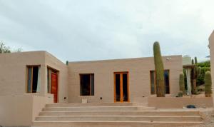 a house with stairs in front of it with a cactus at Los Cardones in Maimará