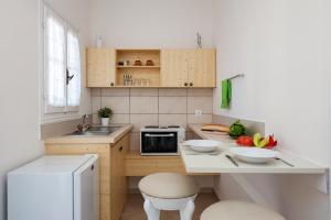 a kitchen with a counter with bowls of fruit on it at The Orange Garden in Kassiopi