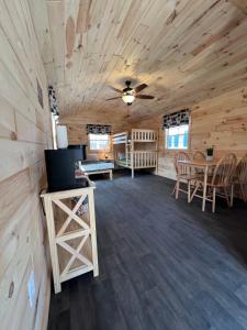a large room with wooden walls and a ceiling at Sister Lakes Glamping Cabin at Wonder Woods #3 in Dowagiac
