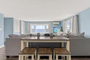 a living room with a couch and a table at The Sunrise Deck Ocean Views Private Deck in Rye