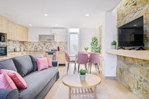 a living room with a couch and a table at Sunny House with Patio, Walk to Attractions in Vila Nova de Gaia