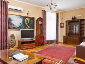 a living room with a television and a table at Apartment Palata Bizanti in Kotor