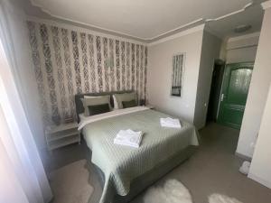 Postel nebo postele na pokoji v ubytování Garni Hotel Bella