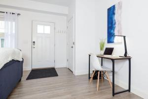 a bedroom with a bed and a desk with a laptop at Steps to Beach King Bed Hampton Beach Hideaway in Hampton