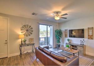 a living room with a couch and a ceiling fan at Modern Farmhouse Mesa Retreat in Mesa