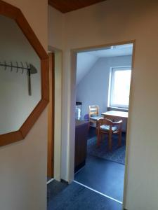 a room with a door leading to a dining room at Ferienwohnungen an der Schusteracht Dachgeschoss und Souterrain in Kiel +12 photos