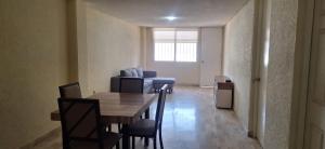 a dining room with a table and chairs and a couch at Apartment on the French Riviera in Acapulco