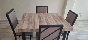 a wooden table with four chairs around it at Apartment on the French Riviera in Acapulco