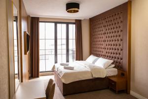 a hotel room with a bed and a large window at Hotel Falcon in Žabljak +77 photos