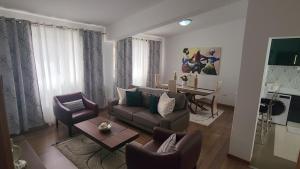 a living room with a couch and chairs and a table at Our Happy Place Prainha in Praia