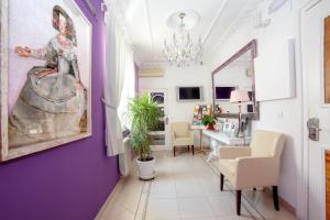 a living room with a painting of a woman on the wall at Hostal Adriano in Madrid