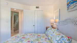 a bedroom with a bed and a mirror and a door at 408 Mariners Club in Key Largo +37 photos
