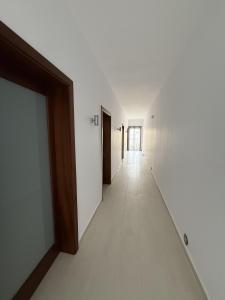 an empty hallway with white walls and a long corridor at Sunny Escape Seaside in Sliema