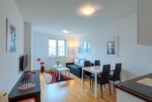 a living room with a couch and a table at Apartamenty Diva Kołobrzeg in Kołobrzeg