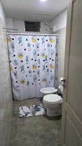 a bathroom with a toilet and a shower curtain at Departamento en Planta baja, centrico, Practico, Estacionamiento D1 in San Fernando del Valle de Catamarca +12 photos