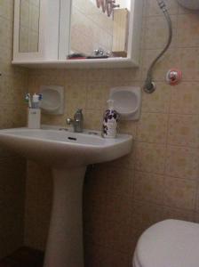 a bathroom with a sink and a toilet at Casa Alieta in Torre Lapillo